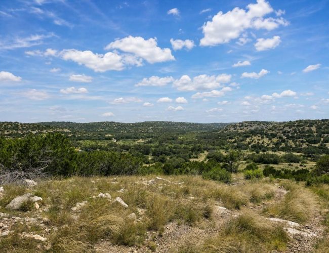 3E Ranch rocky grassland overlooking rolling wooded hills, Edwards County, Texas