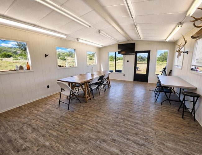 3E Ranch mess hall dining room with long wooden table and windows