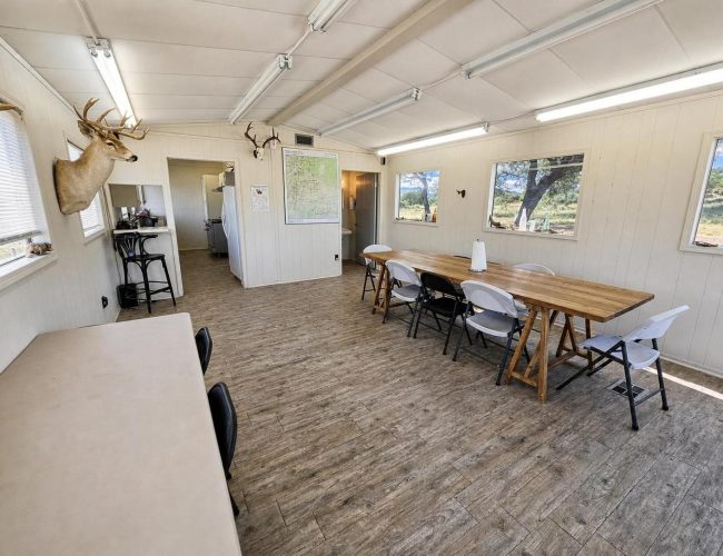 3E Ranch mess hall dining area with view into the kitchen