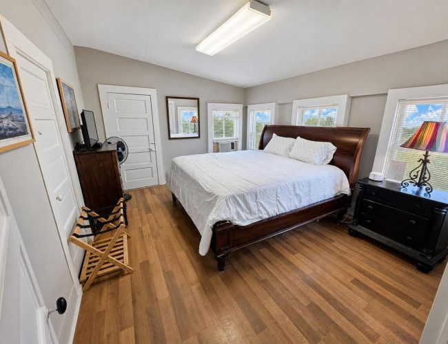 3E Ranch bedroom with large sleigh bed and bright windows
